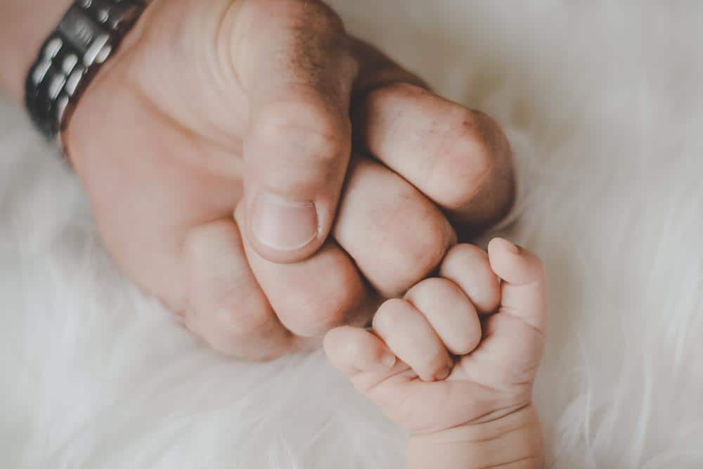Father and child fist bumping