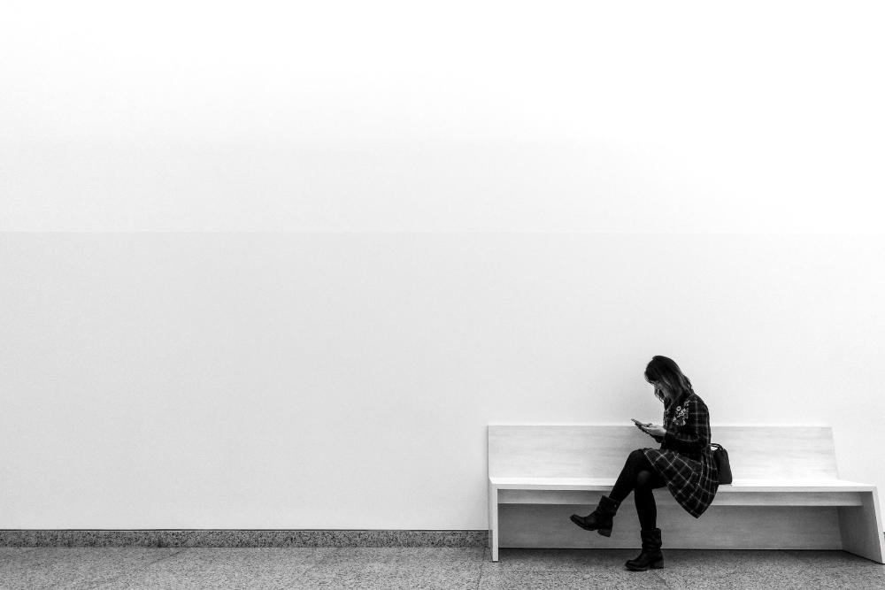 girl sitting on a bench alone
