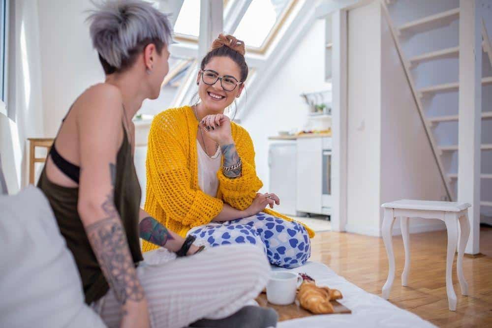 Two persons laughing while looking at each other