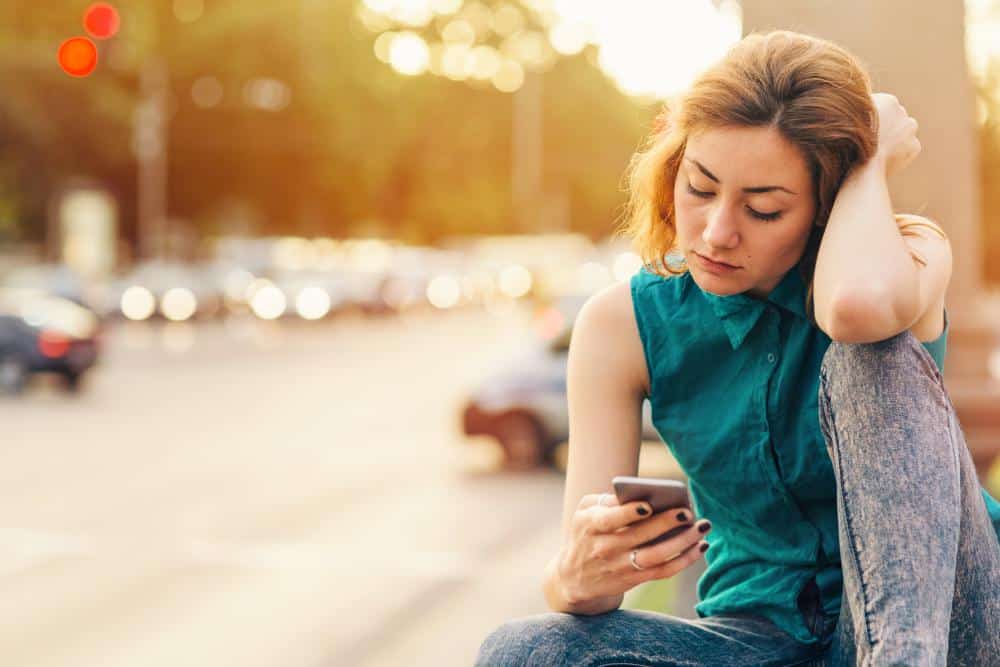 A girl looking at past memories on her phone