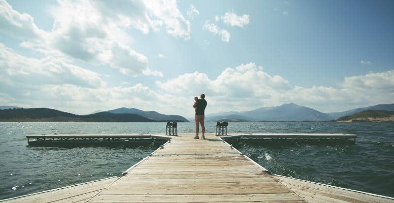 Father and child watching the ocean.