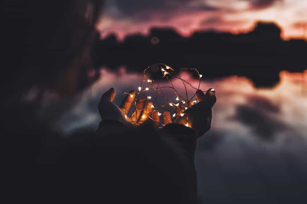 A girl holding fairy lights