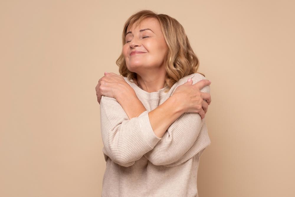 A woman hugging herself showing self-love