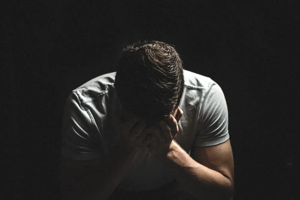 man sitting alone in the dark