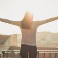 a woman standing with her arms wide open