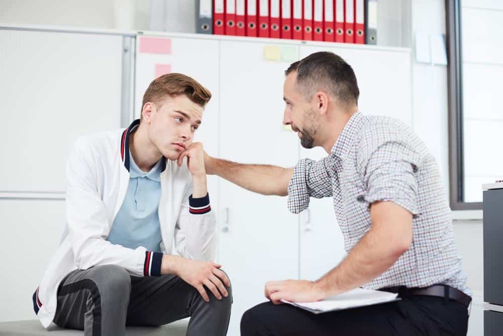 A man consoling his colleague