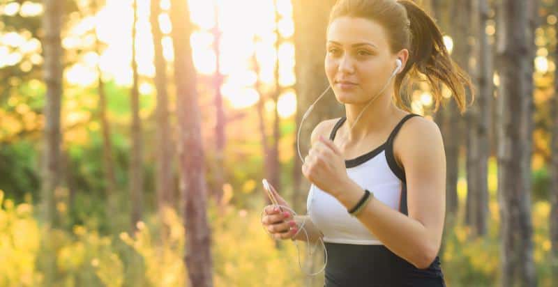 A woman jogging while listening to music