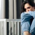 Depressed woman sitting in her room