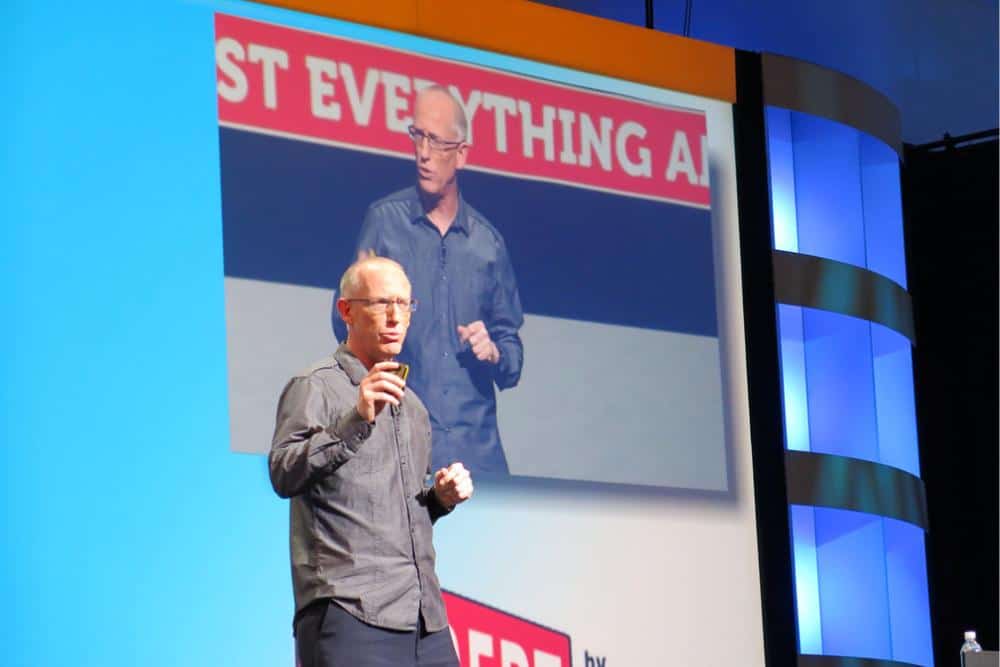 Scott Adams giving a talk in front of a large live audience