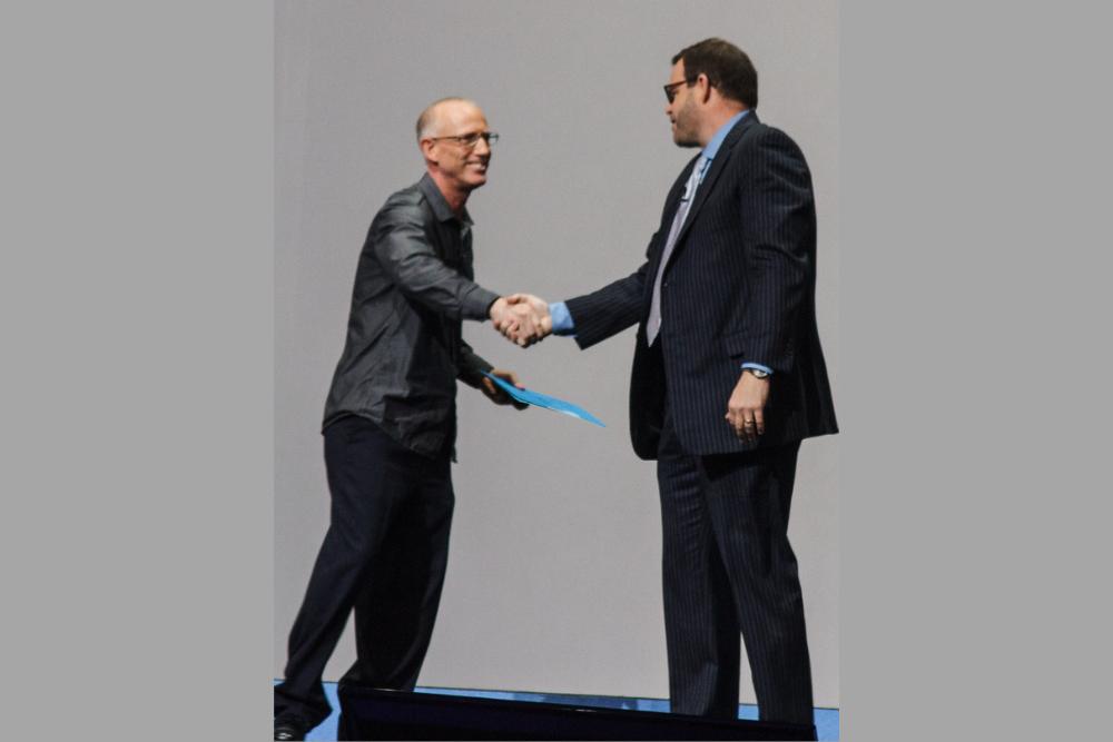 Scott Adams shaking hands with a man