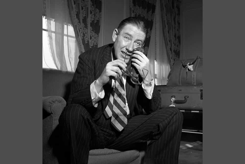 Ogden Nash sitting on a sofa