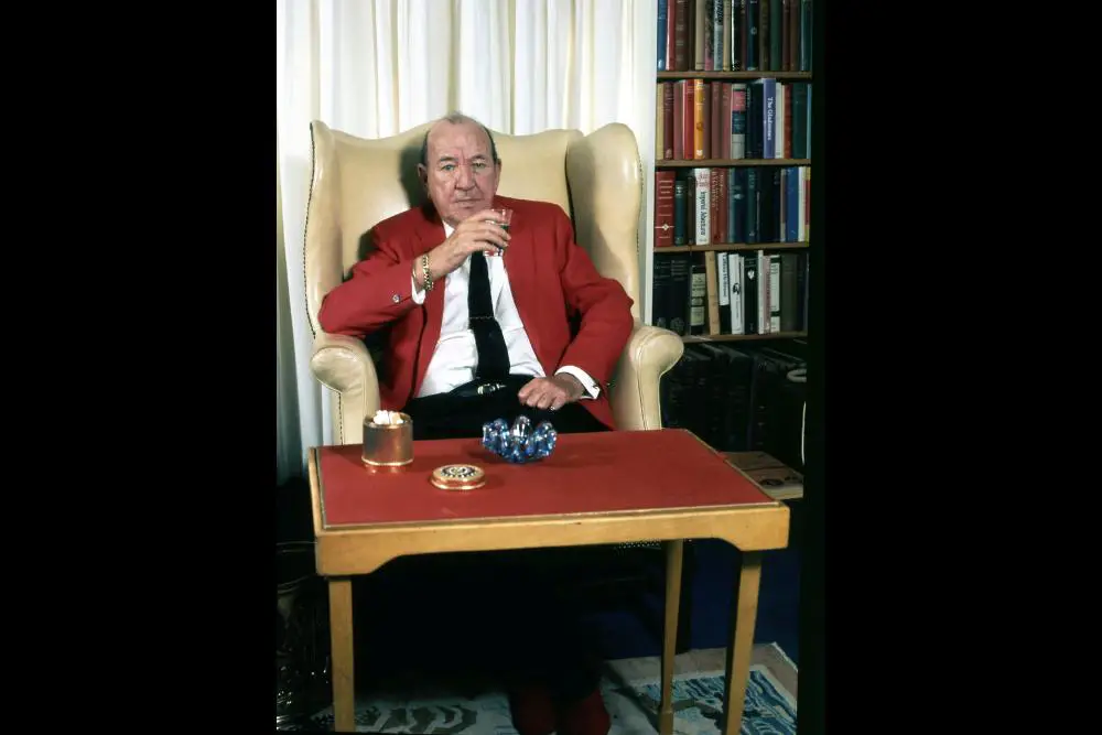 Sir Noël Coward sitting in his study